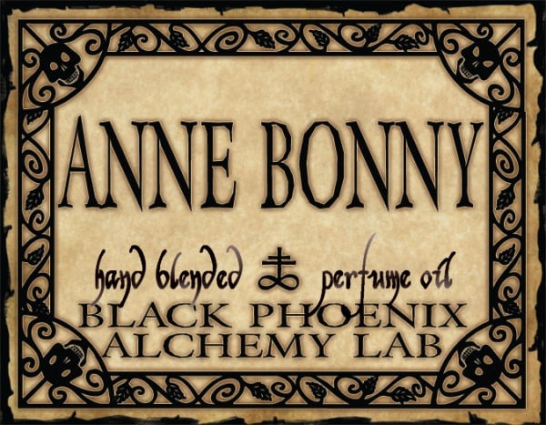 Label for Anne Bonny perfume oil by Black Phoenix Alchemy Lab with decorative border.