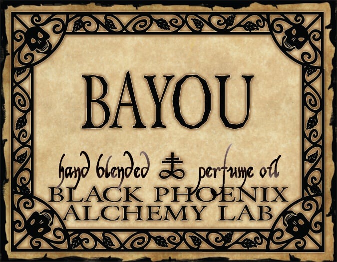Label for Bayou hand blended perfume oil by Black Phoenix Alchemy Lab with decorative border.