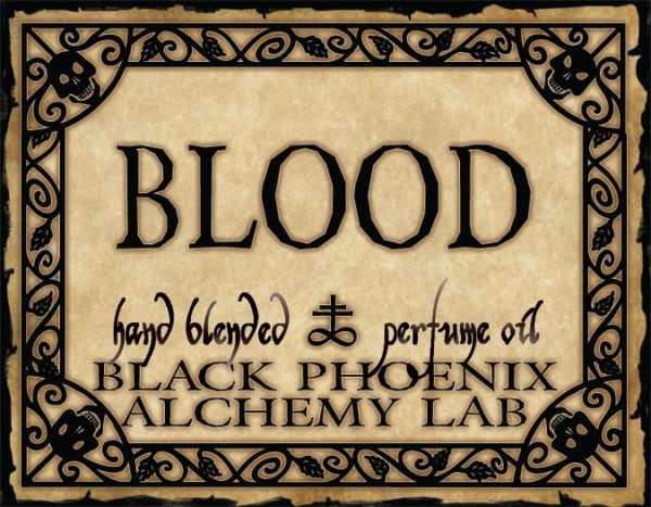 Label for 'Blood' hand blended perfume oil by Black Phoenix Alchemy Lab with decorative border.