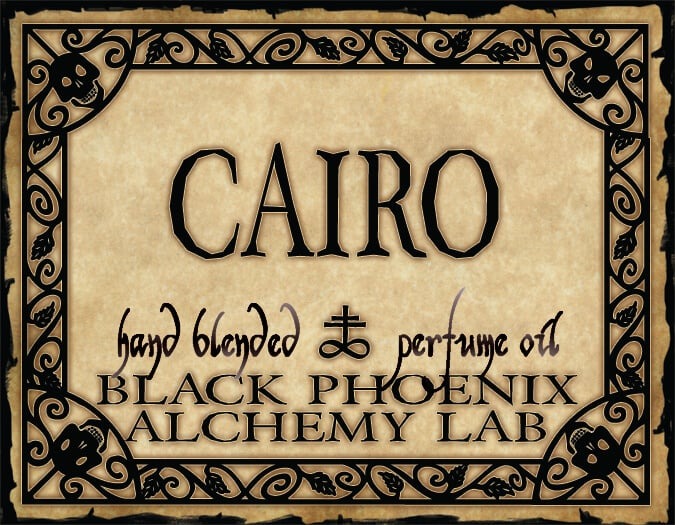 Label for 'Cairo' hand blended perfume oil by Black Phoenix Alchemy Lab with decorative border.