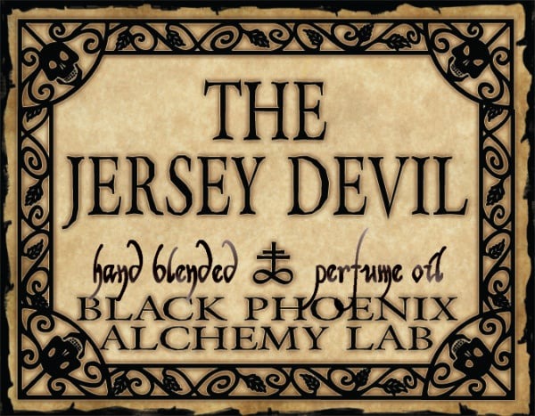 Label for 'The Jersey Devil' perfume oil by Black Phoenix Alchemy Lab with decorative border.