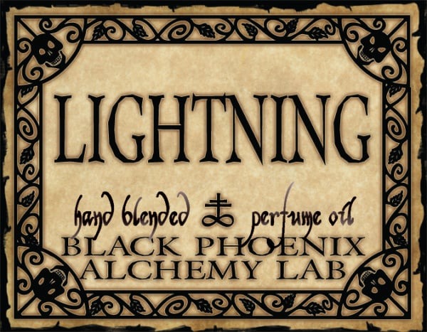 Label for 'Lightning' hand blended perfume oil by Black Phoenix Alchemy Lab with decorative border.