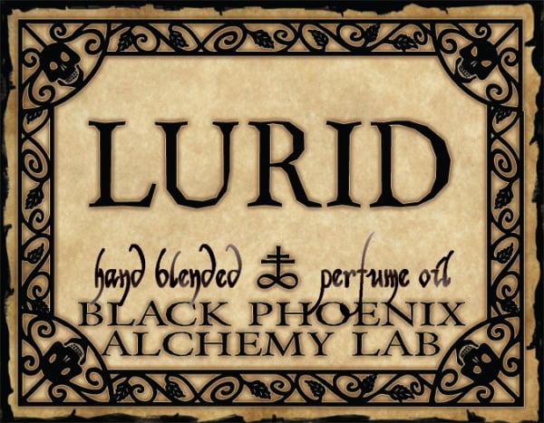 Label for 'Lurid' hand blended perfume oil by Black Phoenix Alchemy Lab with decorative border.