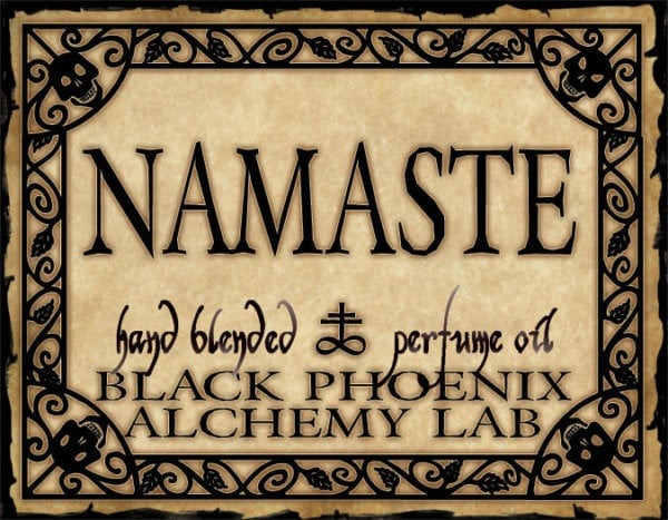 Namaste hand blended perfume oil label from Black Phoenix Alchemy Lab with decorative border.