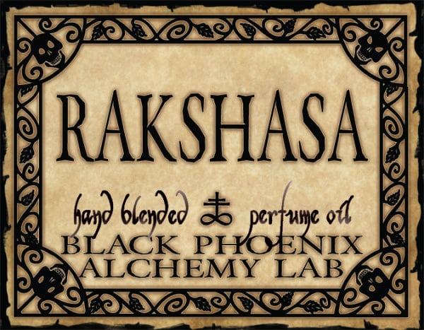 Label for Rakshasa hand blended perfume oil by Black Phoenix Alchemy Lab with decorative border.