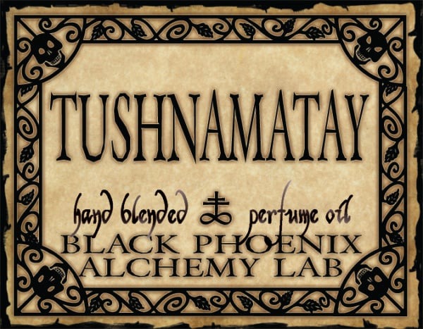 Label for Tushnamatay hand blended perfume oil from Black Phoenix Alchemy Lab with decorative border.