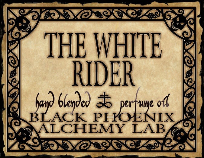 Label for 'The White Rider' hand blended perfume oil by Black Phoenix Alchemy Lab with decorative border.