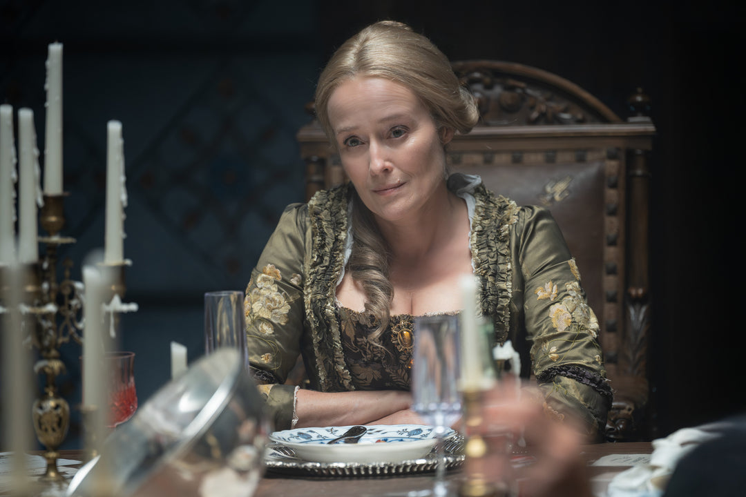 Gabriella seated at a candlelit dinner table in period costume — The Vampire Lestat x AMC, Interview with the Vampire Season 3
