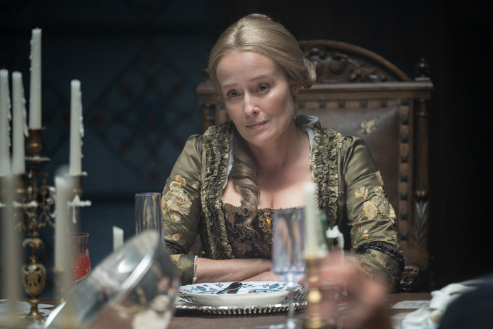 Gabriella seated at a candlelit dinner table in period costume — The Vampire Lestat x AMC, Interview with the Vampire Season 3