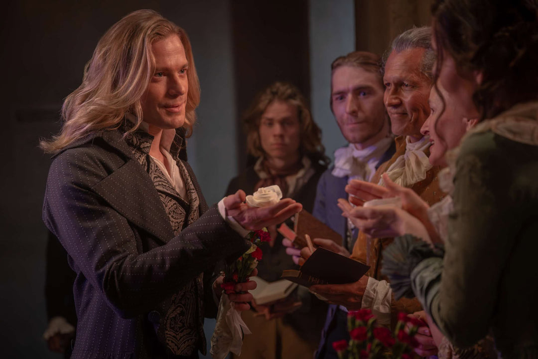 Lestat de Lioncourt in period costume offering a white rose — The Vampire Lestat x AMC, Interview with the Vampire Season 3

