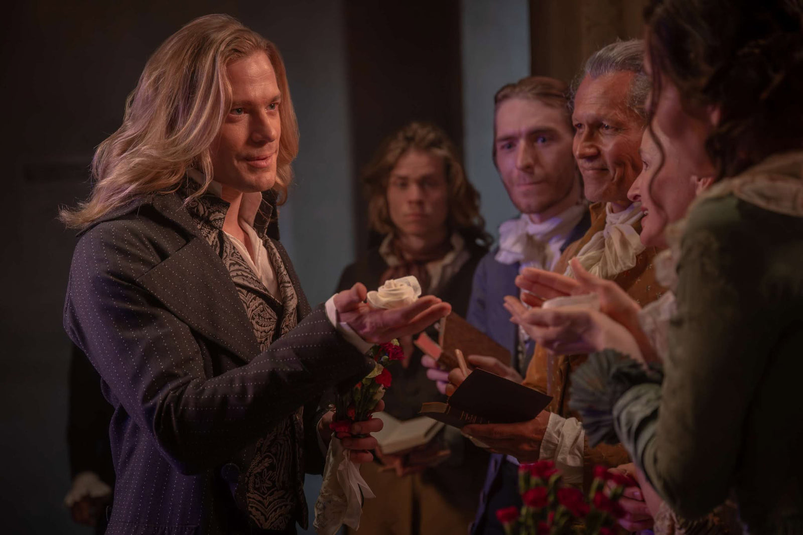 Lestat de Lioncourt in period costume offering a white rose — The Vampire Lestat x AMC, Interview with the Vampire Season 3
