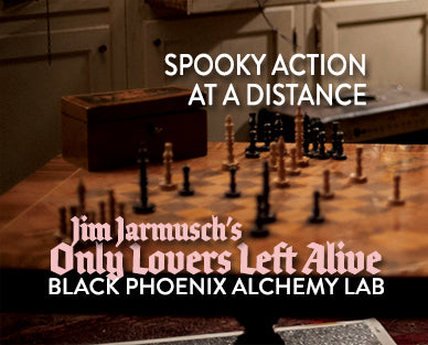 Wooden chessboard with black pieces on a wooden floor, text overlay about &