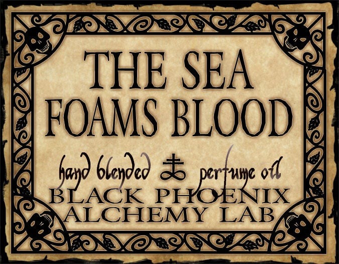 Label for 'The Sea Foams Blood' perfume oil by Black Phoenix Alchemy Lab with decorative border.
