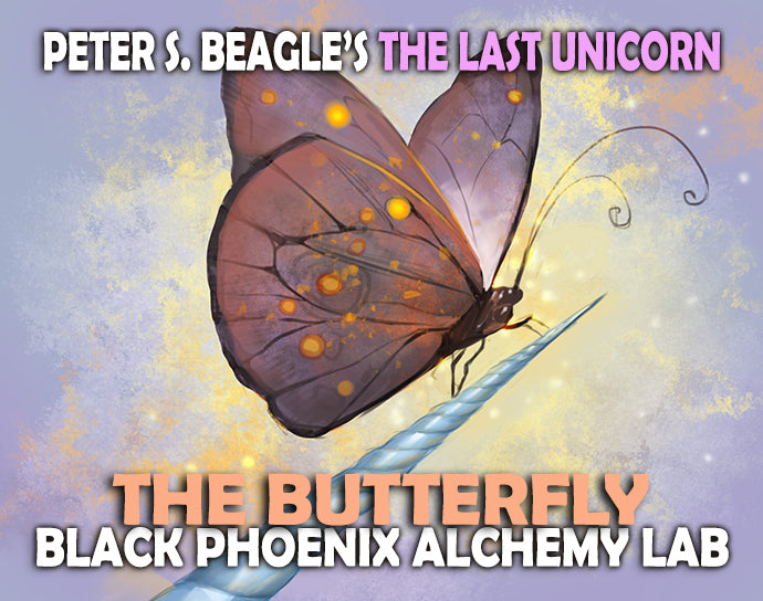 Butterfly on a unicorn horn with text about 'The Last Unicorn' and 'Black Phoenix Alchemy Lab'.