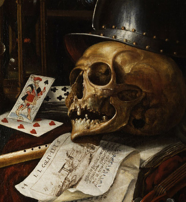 Vanitas painting of a skull with playing cards, a helmet, a book, and a musical instrument